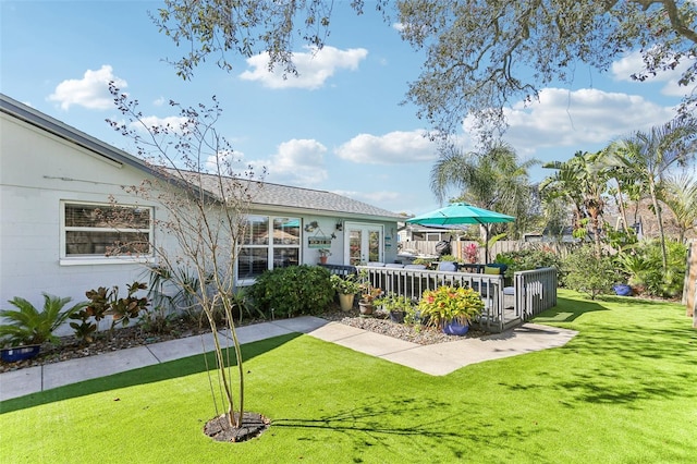 exterior space with fence and a yard