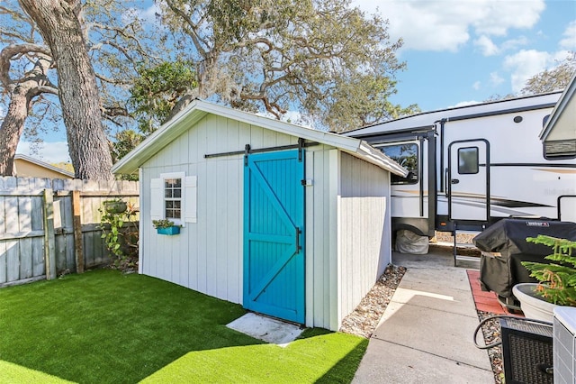 view of shed with a fenced backyard