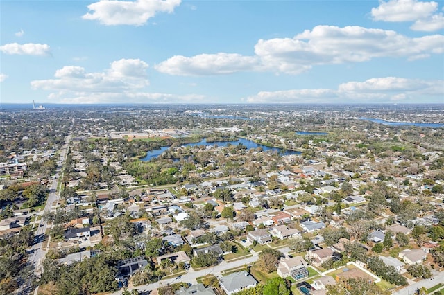 drone / aerial view featuring a water view and a residential view