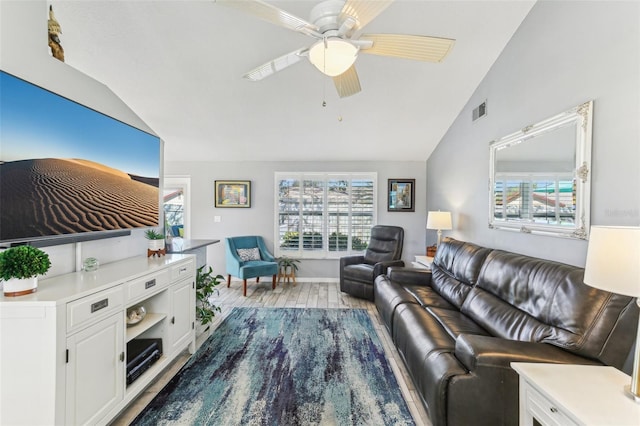 living room featuring lofted ceiling, ceiling fan, visible vents, and wood finished floors