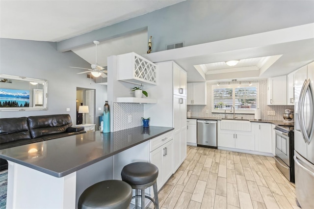 kitchen featuring stainless steel appliances, visible vents, decorative backsplash, open shelves, and dark countertops