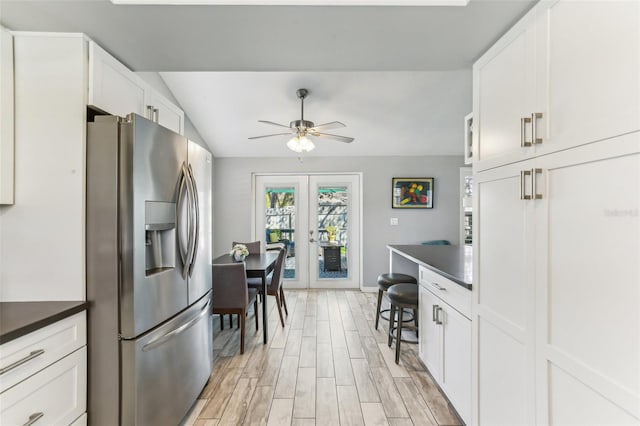 kitchen with white cabinets, french doors, and stainless steel fridge with ice dispenser