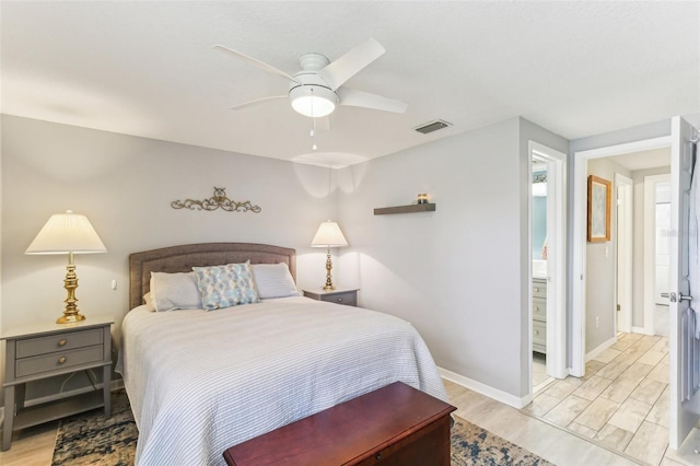 bedroom featuring a ceiling fan, light wood-type flooring, visible vents, and baseboards