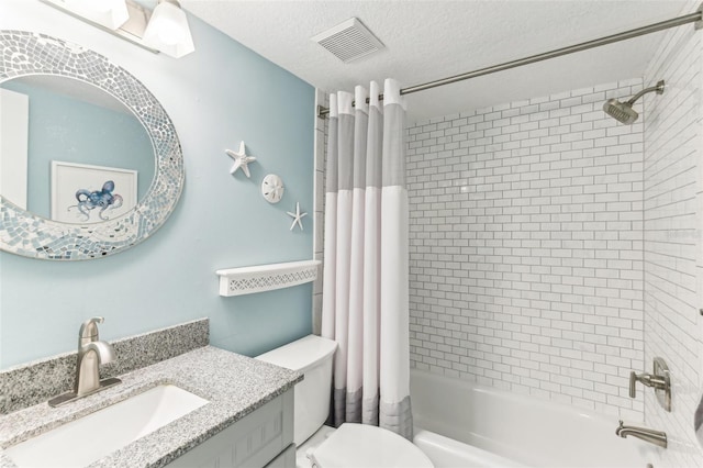 bathroom featuring visible vents, toilet, shower / bath combo with shower curtain, a textured ceiling, and vanity