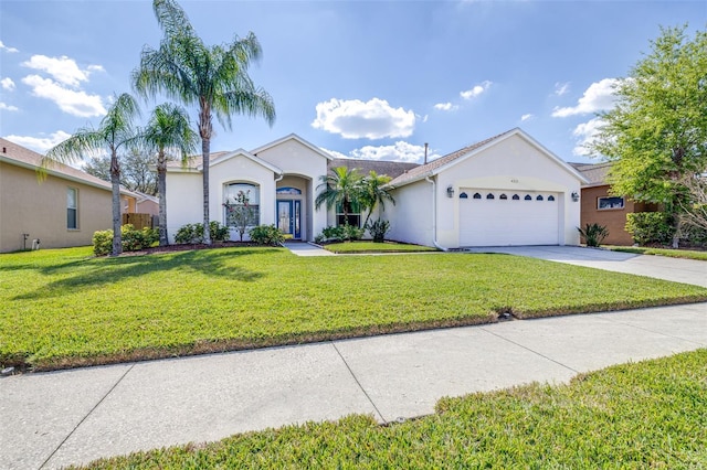 single story home featuring a garage, a front yard, concrete driveway, and stucco siding