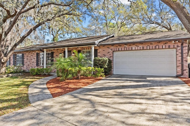 ranch-style house featuring an attached garage, driveway, and brick siding