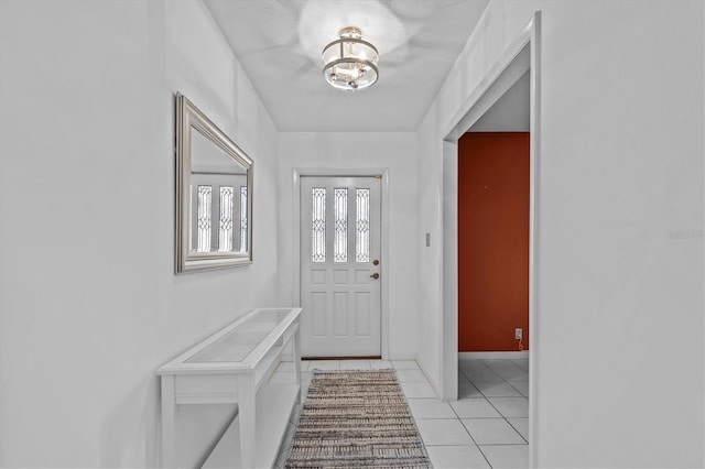 entryway featuring baseboards and light tile patterned floors