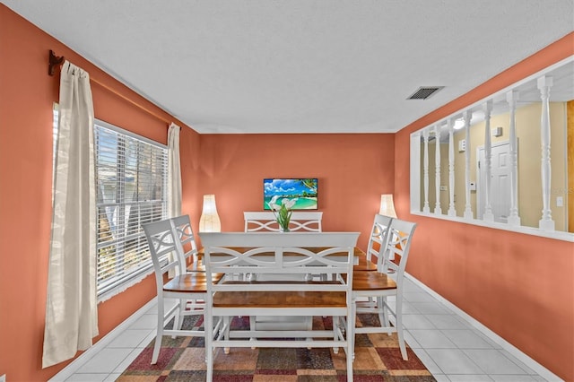 dining room featuring visible vents, plenty of natural light, baseboards, and tile patterned floors