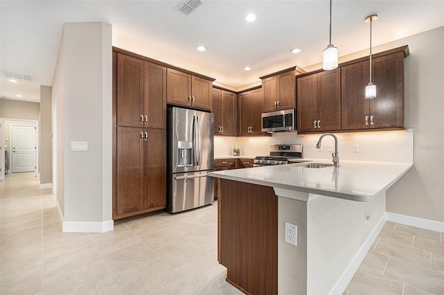 kitchen featuring a peninsula, visible vents, appliances with stainless steel finishes, and a sink