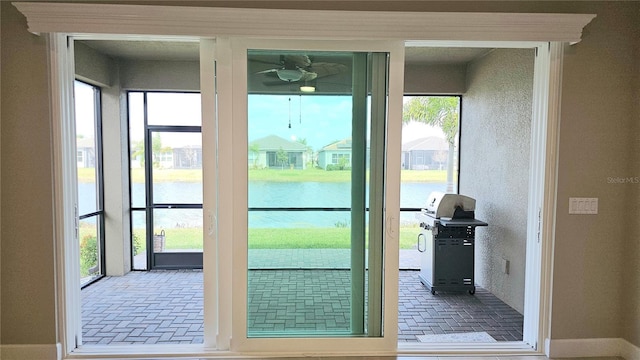 doorway featuring brick floor and a water view