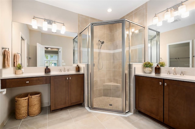 bathroom with tile patterned floors, a shower stall, and vanity