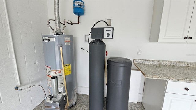 utility room featuring water heater