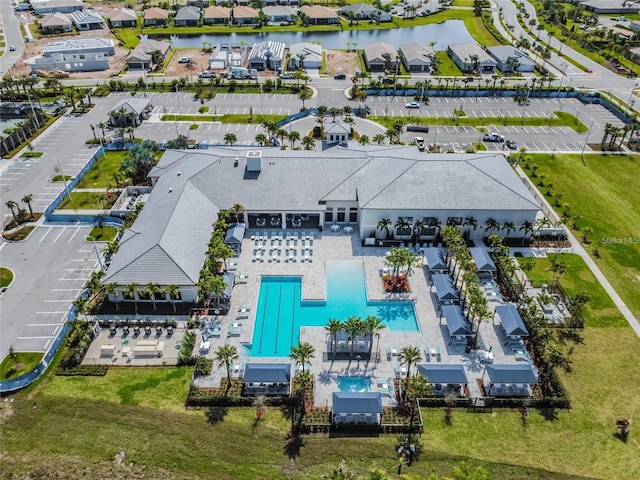 birds eye view of property with a water view and a residential view