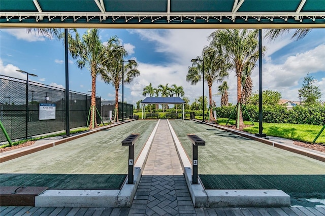 view of home's community featuring fence