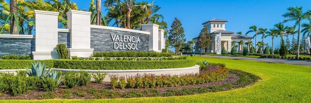 community / neighborhood sign with a lawn