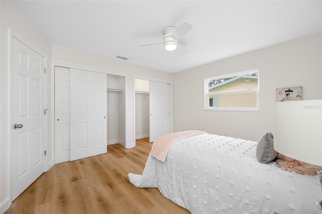 bedroom featuring visible vents, light wood finished floors, and ceiling fan