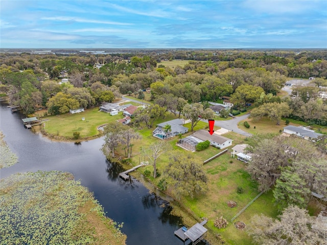 aerial view with a wooded view and a water view