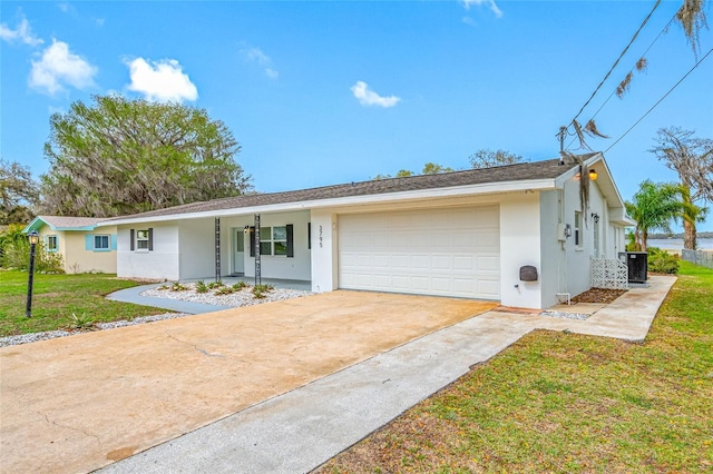 ranch-style house with stucco siding, driveway, a front yard, a garage, and central AC unit