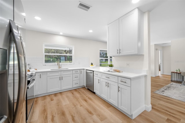 kitchen with a sink, visible vents, appliances with stainless steel finishes, and a wealth of natural light