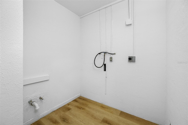 laundry area with washer hookup, laundry area, light wood-style flooring, hookup for a gas dryer, and hookup for an electric dryer