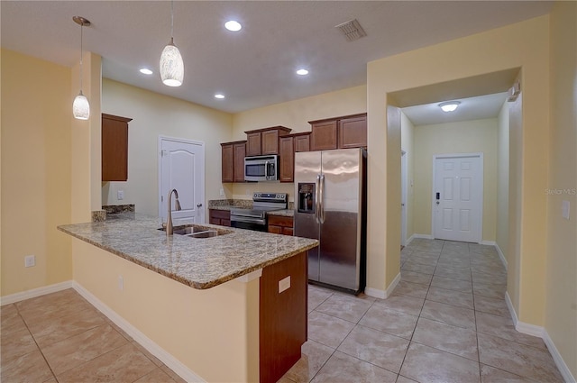 kitchen with light tile patterned floors, visible vents, a peninsula, stainless steel appliances, and a sink