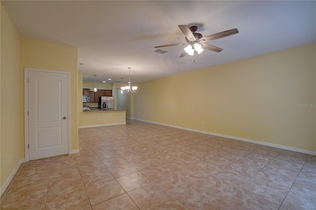 interior space with visible vents, baseboards, and ceiling fan with notable chandelier