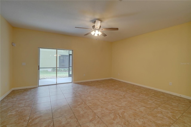 empty room featuring light tile patterned floors, baseboards, and a ceiling fan