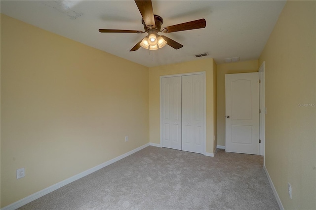 unfurnished bedroom featuring ceiling fan, carpet flooring, visible vents, baseboards, and a closet