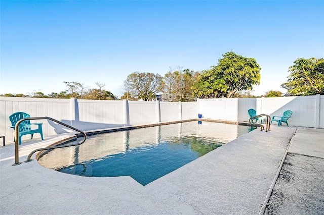 view of swimming pool featuring a fenced backyard and a patio