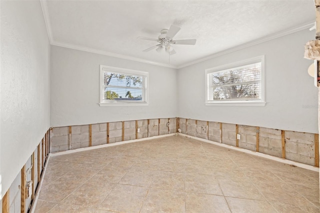 unfurnished room with a ceiling fan and crown molding