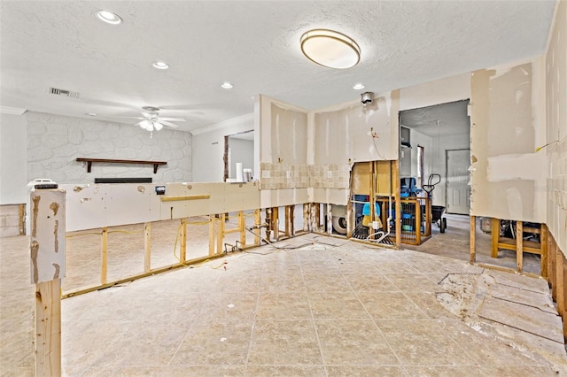 misc room with a textured ceiling, ornamental molding, visible vents, and recessed lighting