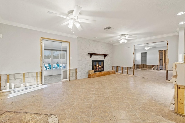 unfurnished living room featuring a ceiling fan, visible vents, a stone fireplace, and ornamental molding