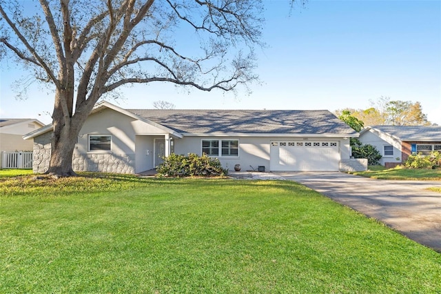 ranch-style house featuring a garage, concrete driveway, a front lawn, and stucco siding