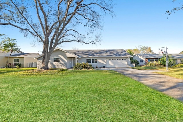 ranch-style home featuring concrete driveway, a front lawn, an attached garage, and stucco siding