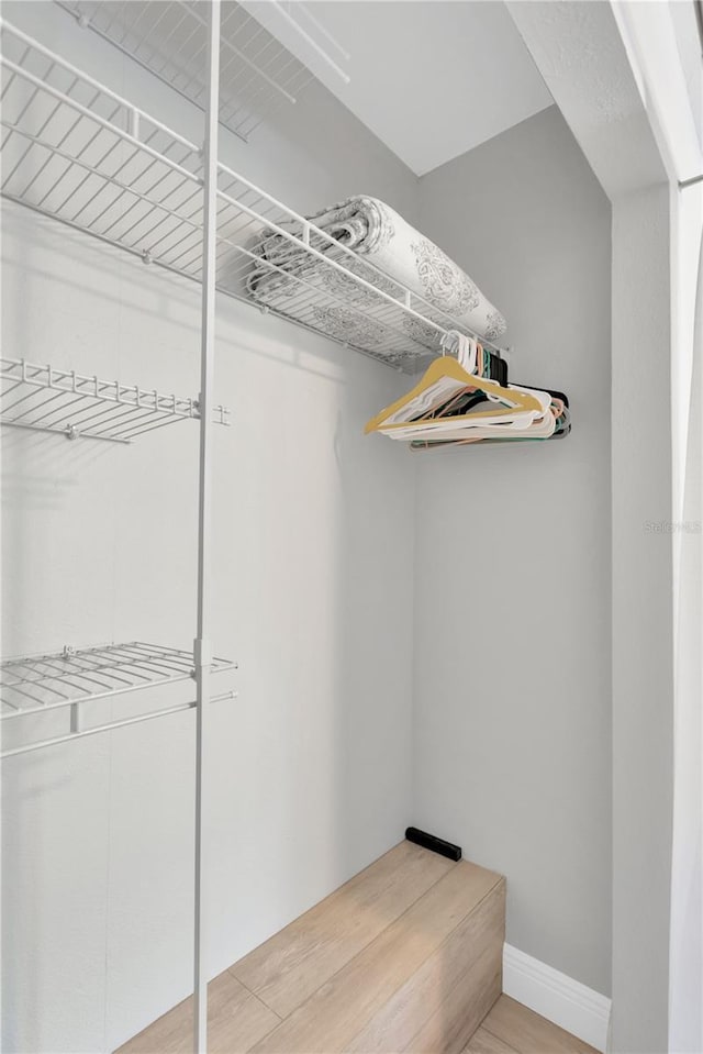 walk in closet with light wood-type flooring