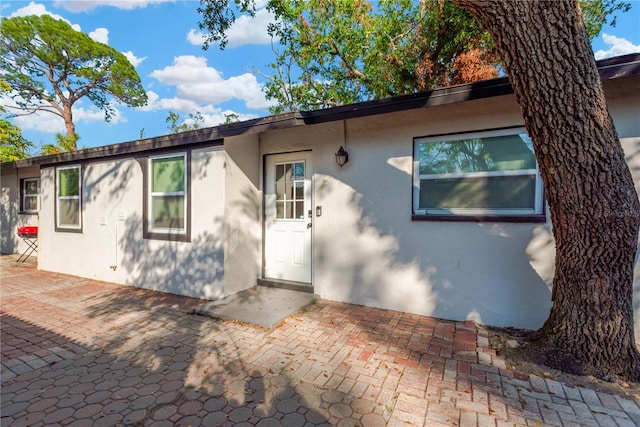 view of front facade with a patio area and stucco siding