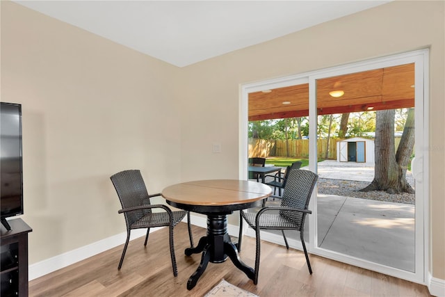 dining area with wood finished floors and baseboards