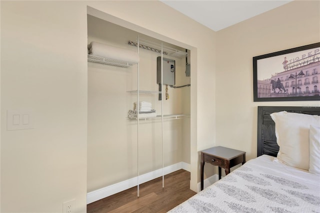 bedroom featuring baseboards, a closet, and wood finished floors