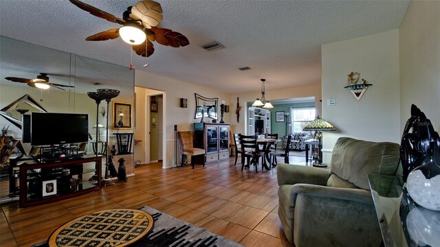 1320 Bottlebrush Dr, Bradenton, FL 34208 - living area featuring ceiling fan and a textured ceiling