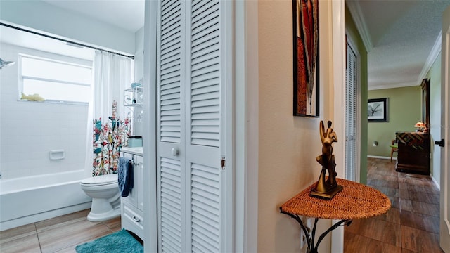 1320 Bottlebrush Dr, Bradenton, FL 34208 - bathroom featuring a closet, toilet, crown molding, shower / bathtub combination with curtain, and wood finished floors