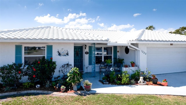 1320 Bottlebrush Dr, Bradenton, FL 34208 - view of front facade with an attached garage, a tile roof, and stucco siding