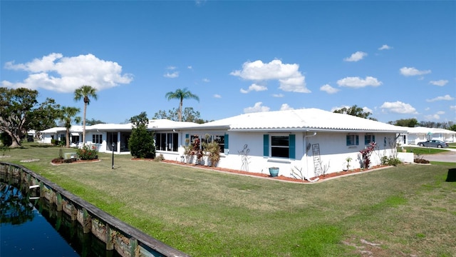 1320 Bottlebrush Dr, Bradenton, FL 34208 - rear view of property with a yard and stucco siding