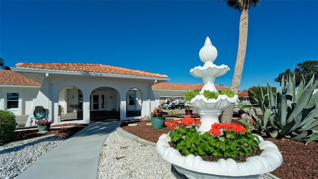 1320 Bottlebrush Dr, Bradenton, FL 34208 - view of front of home featuring covered porch, a tiled roof, and stucco siding