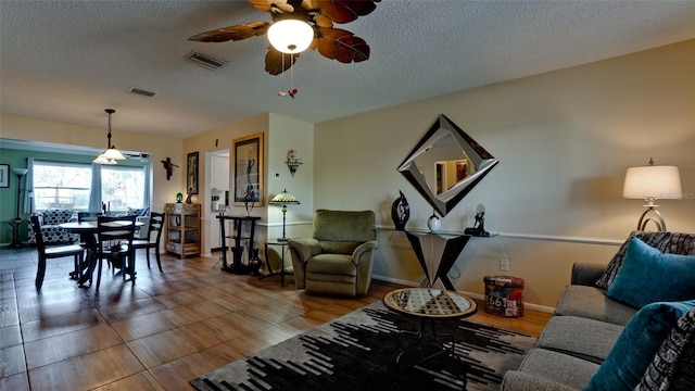 1320 Bottlebrush Dr, Bradenton, FL 34208 - living area featuring ceiling fan, a textured ceiling, and wood finished floors