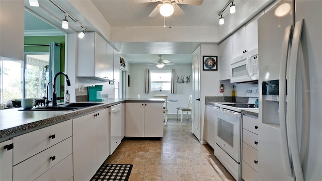1320 Bottlebrush Dr, Bradenton, FL 34208 - kitchen featuring white appliances, a ceiling fan, a sink, a peninsula, and track lighting