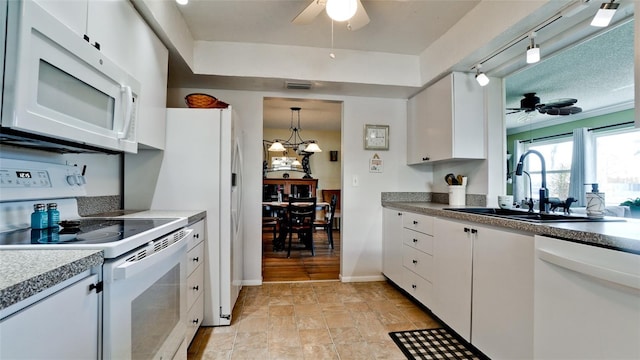 1320 Bottlebrush Dr, Bradenton, FL 34208 - kitchen featuring white appliances, ceiling fan, a sink, and white cabinets