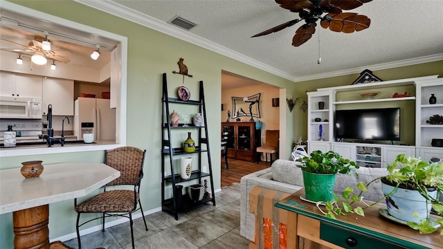 1320 Bottlebrush Dr, Bradenton, FL 34208 - living area with a ceiling fan, crown molding, and a textured ceiling