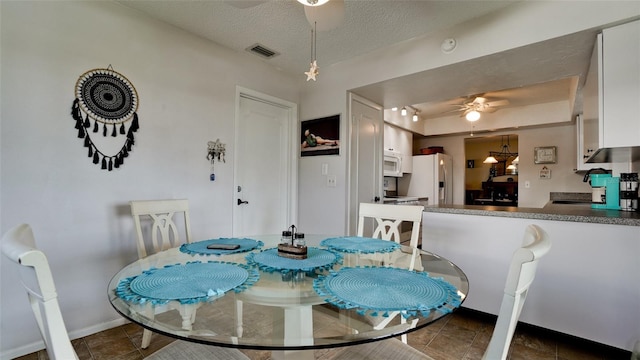 1320 Bottlebrush Dr, Bradenton, FL 34208 - dining room with a ceiling fan, a textured ceiling, and baseboards