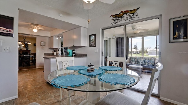 1320 Bottlebrush Dr, Bradenton, FL 34208 - dining space with a ceiling fan, baseboards, and a textured ceiling
