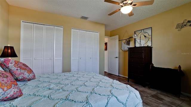 1320 Bottlebrush Dr, Bradenton, FL 34208 - bedroom featuring two closets, a textured ceiling, ceiling fan, and baseboards